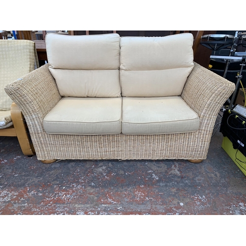 248 - A modern wicker and fabric upholstered two seater sofa