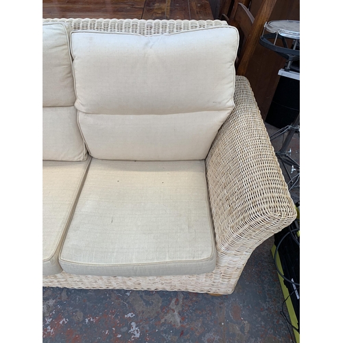 248 - A modern wicker and fabric upholstered two seater sofa