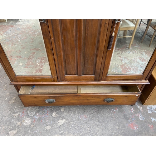 59 - An Edwardian carved walnut double mirror door wardrobe - approx. 202cm high x 165cm wide x 53cm deep