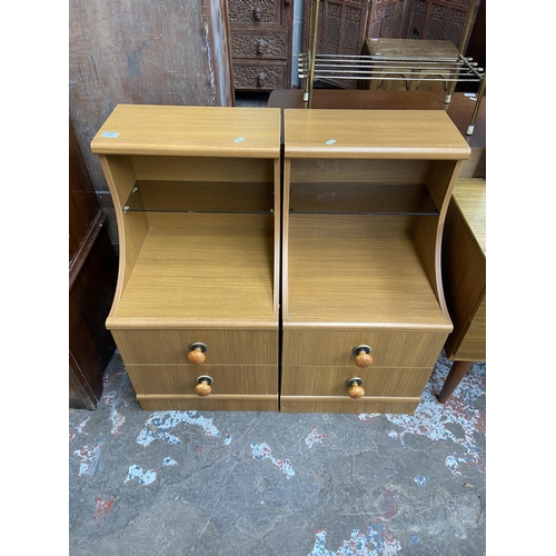 60 - A pair of teak effect two drawer bedside cabinets - approx. 83cm high x 44cm wide x 47cm deep