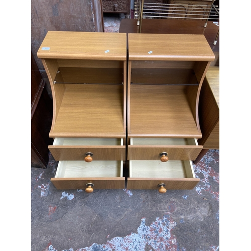 60 - A pair of teak effect two drawer bedside cabinets - approx. 83cm high x 44cm wide x 47cm deep