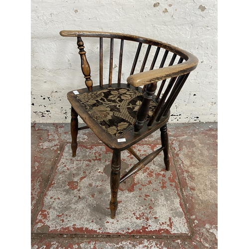 63 - A late 19th century elm spindle back elbow chair with fabric upholstered seat - approx. 72cm high x ... 