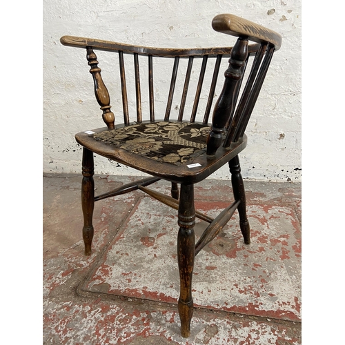 63 - A late 19th century elm spindle back elbow chair with fabric upholstered seat - approx. 72cm high x ... 