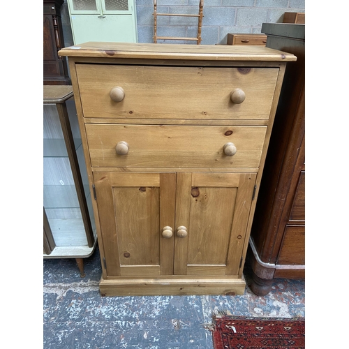 68 - A modern solid pine two door cabinet - approx. 116cm high x 74cm wide x 35cm deep