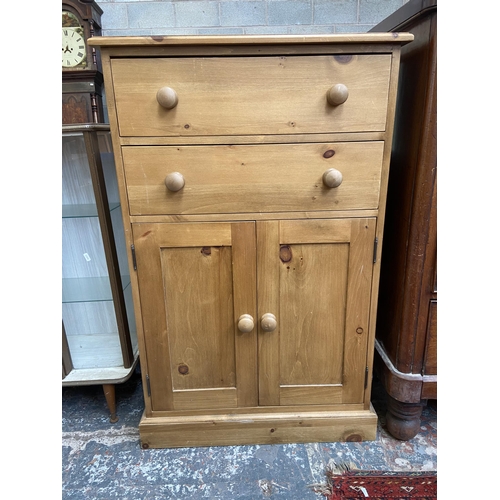 68 - A modern solid pine two door cabinet - approx. 116cm high x 74cm wide x 35cm deep