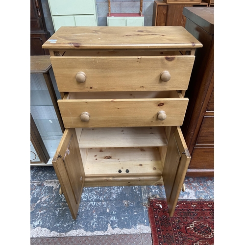 68 - A modern solid pine two door cabinet - approx. 116cm high x 74cm wide x 35cm deep