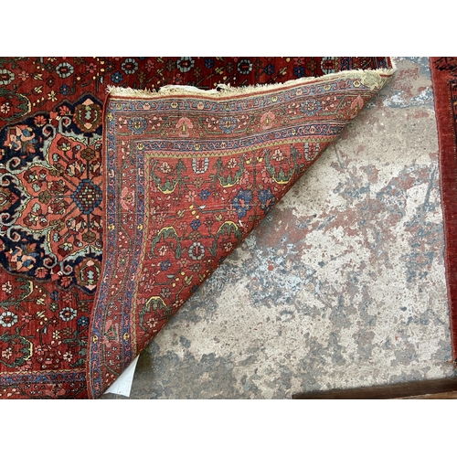 75 - A late 19th/early 20th century Persian hand knotted rug - approx. 162cm x 110cm