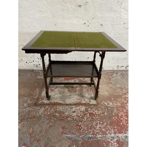 78 - An Edwardian mahogany fold over games table/trolley with green baize interior - approx. 74cm high x ... 