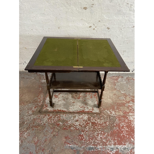 78 - An Edwardian mahogany fold over games table/trolley with green baize interior - approx. 74cm high x ... 