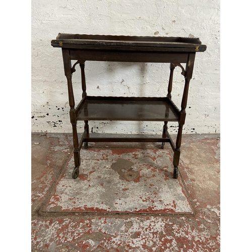 78 - An Edwardian mahogany fold over games table/trolley with green baize interior - approx. 74cm high x ... 