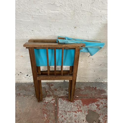 79 - A pair of teak and pale blue fabric director's chairs