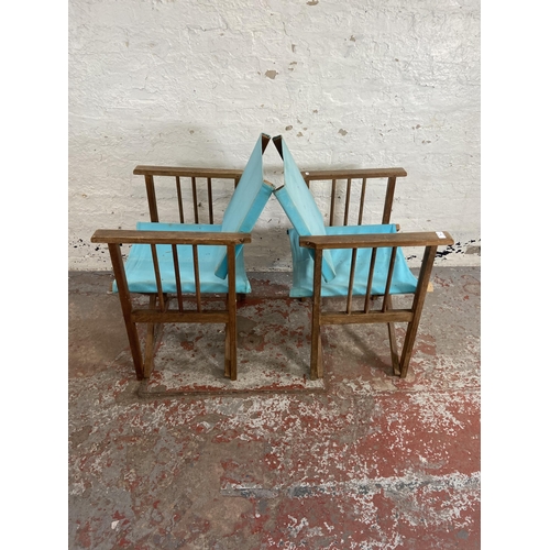 79 - A pair of teak and pale blue fabric director's chairs