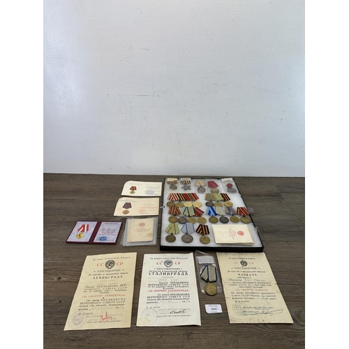 2310 - A collection of Russian military medals and paperwork to include The Order of Glory 3rd Class, 1930s... 