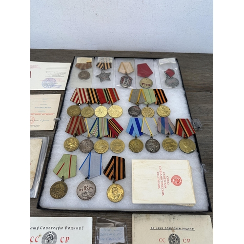 2310 - A collection of Russian military medals and paperwork to include The Order of Glory 3rd Class, 1930s... 