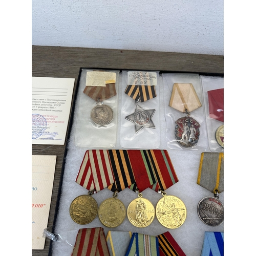 2310 - A collection of Russian military medals and paperwork to include The Order of Glory 3rd Class, 1930s... 