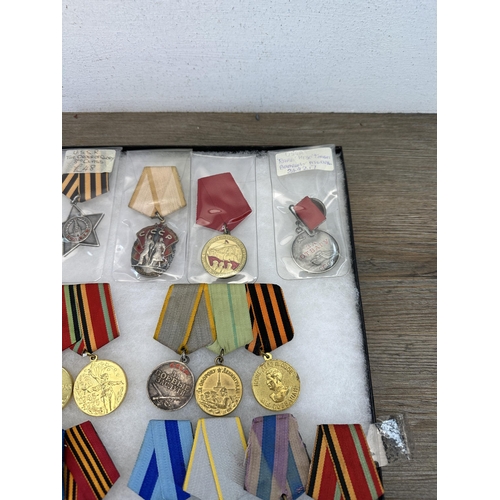 2310 - A collection of Russian military medals and paperwork to include The Order of Glory 3rd Class, 1930s... 