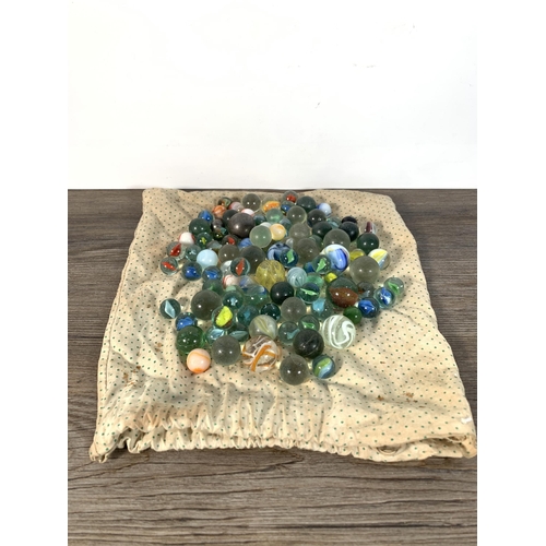 410 - A collection of antique and later glass and metal marbles