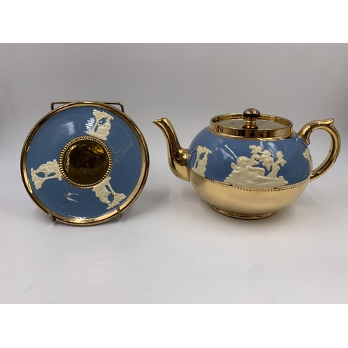 314 - A Gibsons Blue Jasperware and gilt four piece tea set