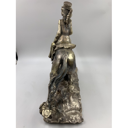 324 - An A. Belconi resin horse and rider figurine with inset .925 silver plaque to base - approx. 33cm hi... 