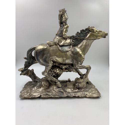 324 - An A. Belconi resin horse and rider figurine with inset .925 silver plaque to base - approx. 33cm hi... 