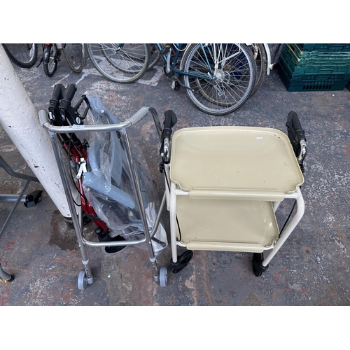 872 - Four pieces of mobility equipment to include toilet and three various walking frames