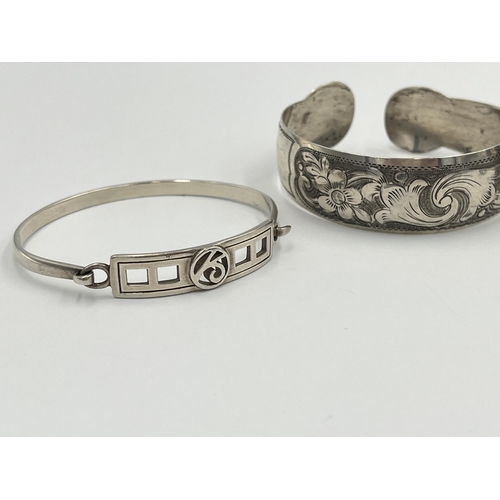 2036 - Four silver and white metal bangles to include hallmarked Edinburgh, Continental .835 etc.