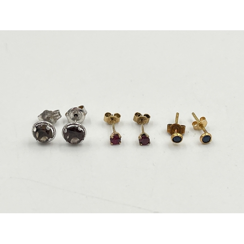 2049 - Three pairs of 9ct gold gemstone set stud earrings, one ruby, one smoky quartz and one sapphire - ap... 