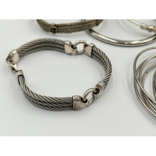 2056 - A collection of white metal bangles