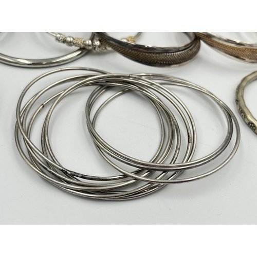 2056 - A collection of white metal bangles