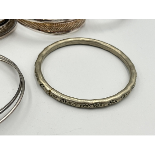 2056 - A collection of white metal bangles