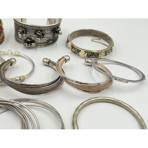 2056 - A collection of white metal bangles