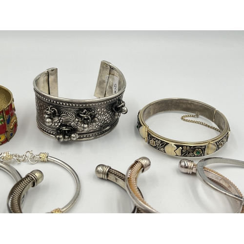 2056 - A collection of white metal bangles