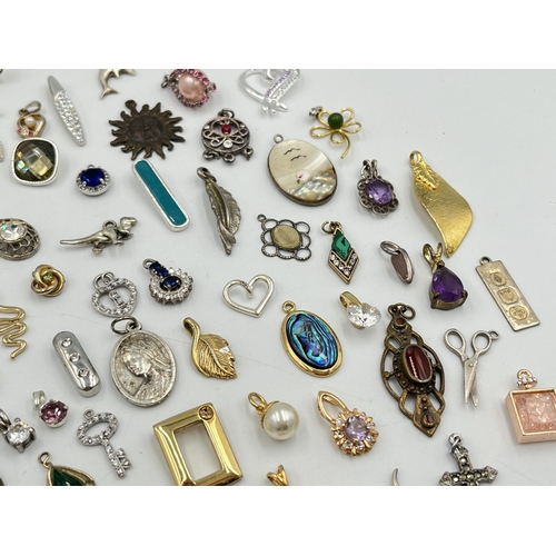 2063 - A collection of pendants to include abalone, mother of pearl, white metal etc.