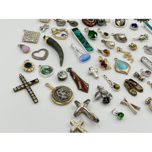 2063 - A collection of pendants to include abalone, mother of pearl, white metal etc.