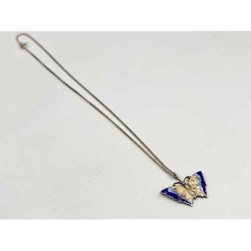 2084 - A guilloche enamel and white metal butterfly pendant on .925 silver chain