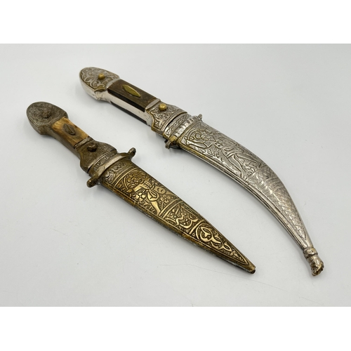 Two Islamic daggers with scabbards, and engraved decoration