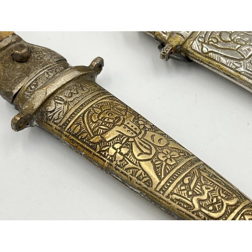 2114A - Two Islamic daggers with scabbards, and engraved decoration