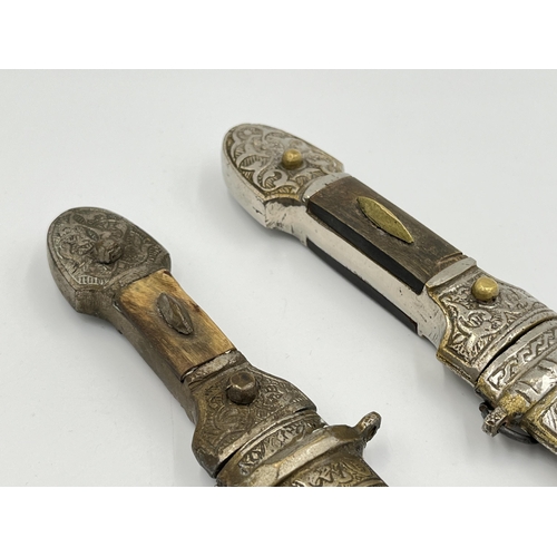 2114A - Two Islamic daggers with scabbards, and engraved decoration