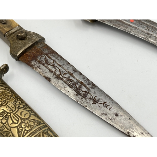 2114A - Two Islamic daggers with scabbards, and engraved decoration