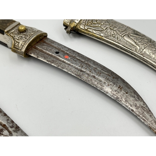 2114A - Two Islamic daggers with scabbards, and engraved decoration