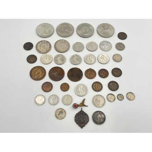 2180 - A collection of worldwide coins to include four silver and five 50% silver, Royal Air Force brass an... 