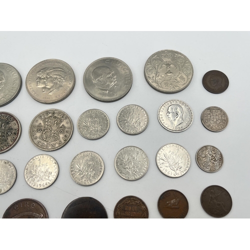 2180 - A collection of worldwide coins to include four silver and five 50% silver, Royal Air Force brass an... 