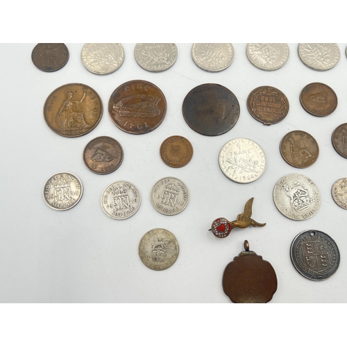 2180 - A collection of worldwide coins to include four silver and five 50% silver, Royal Air Force brass an... 