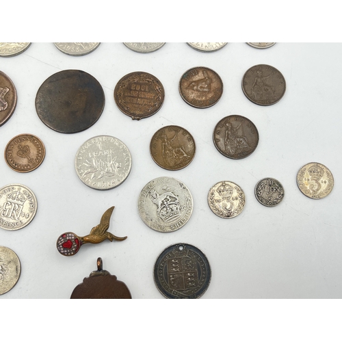 2180 - A collection of worldwide coins to include four silver and five 50% silver, Royal Air Force brass an... 