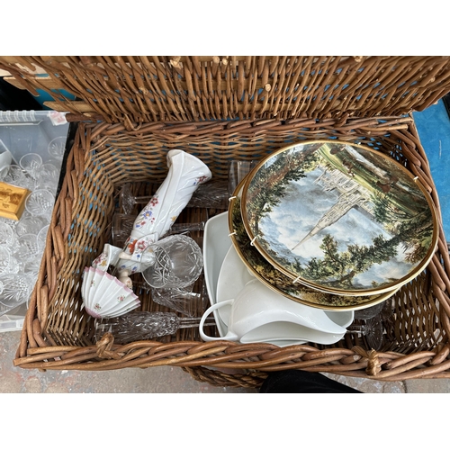 1023 - A mid 20th century Mossman travel chest, one box and wicker basket containing cut crystal glassware,... 