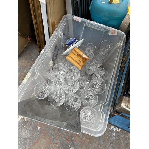 1023 - A mid 20th century Mossman travel chest, one box and wicker basket containing cut crystal glassware,... 