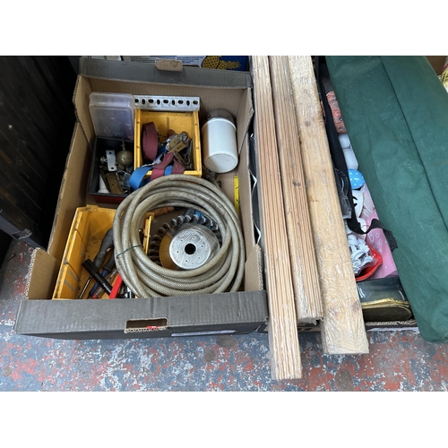 1027 - Nine boxes containing Victorian brass finial, Screwfix screws, linen material, blankets, nails, glas... 