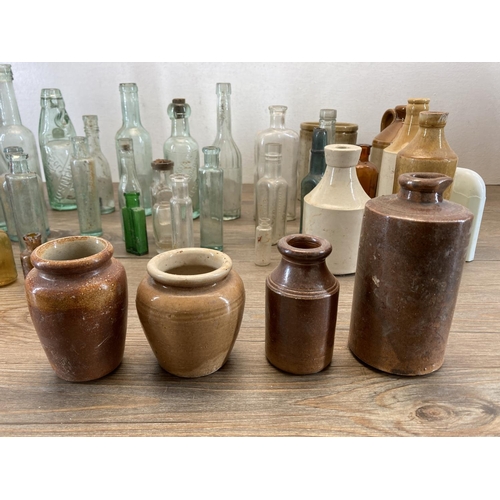 332 - A collection of early 20th century glass and stoneware bottles