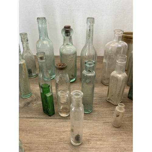 332 - A collection of early 20th century glass and stoneware bottles