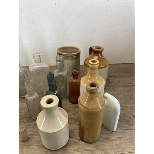 332 - A collection of early 20th century glass and stoneware bottles